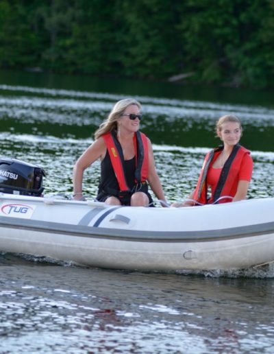 Inflatable Boat with Mother and daughter on a lake